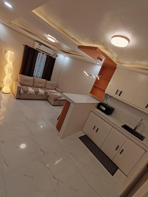 a kitchen and a living room with a couch at Townhouse in Malolos - Ezzy Good Spot in Malolos