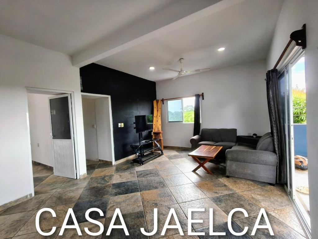 a living room with a couch and a table at spacious apartment with ocean view in Brisas de Zicatela