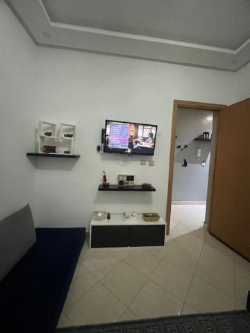 a room with a tv on a white wall at Résidences tazerzit smouna in Agadir