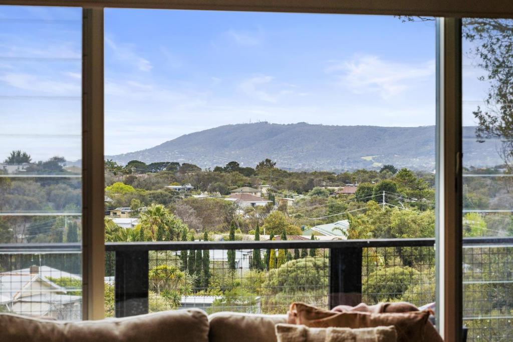 a living room with a view of a mountain at Nautilus Rise – Panoramic Bay Coastal Views in Tootgarook
