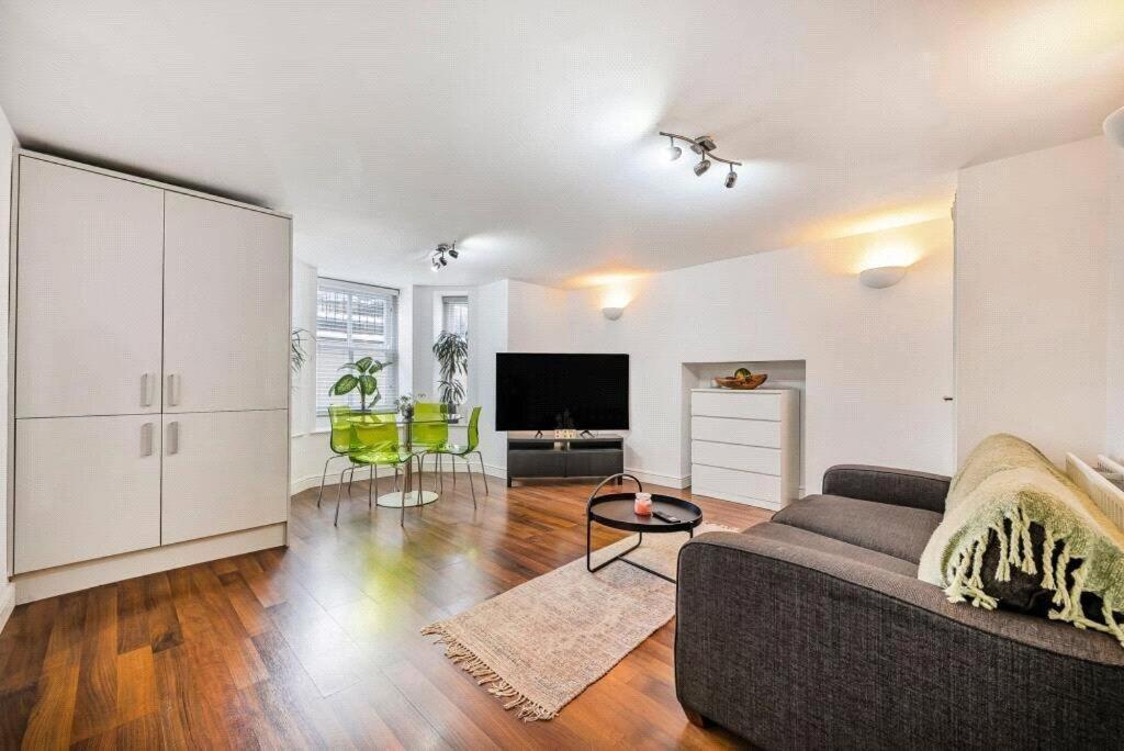 a living room with a couch and a tv at Central 2-Bed, 2-Bath Apartment in Harrogate