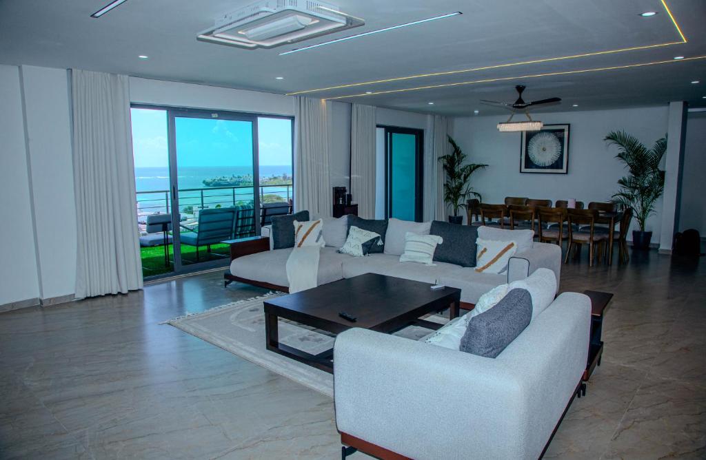 a living room with a couch and a table at Semo's Aqua luxury 6 bedrooms Penthouse sea views in Mombasa