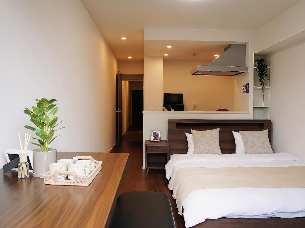 a hotel room with two beds and a desk at Poka Premium Kuramae Luxury 2BR Suite Brand-New in Tokyo
