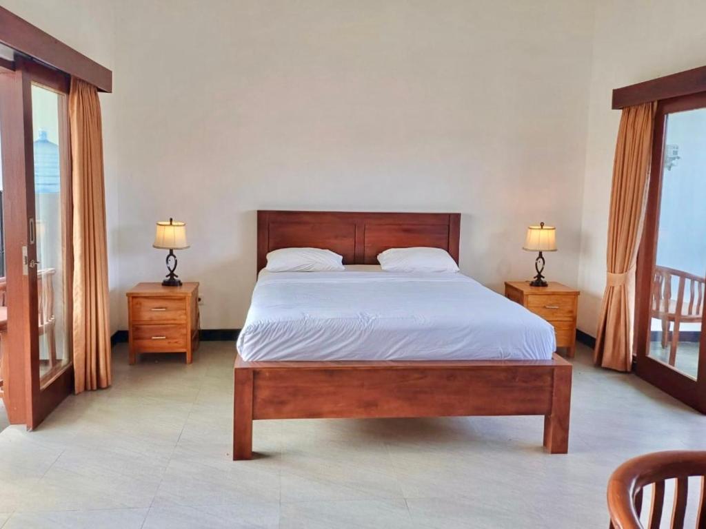 a bedroom with a large bed and two night stands at Luka's Place - 1 bedroom in Cemagi