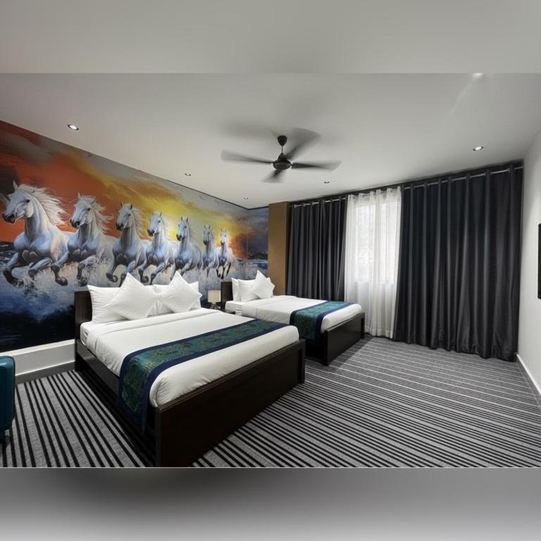 a bedroom with two beds and a painting of horses at Silk White in Hyderabad