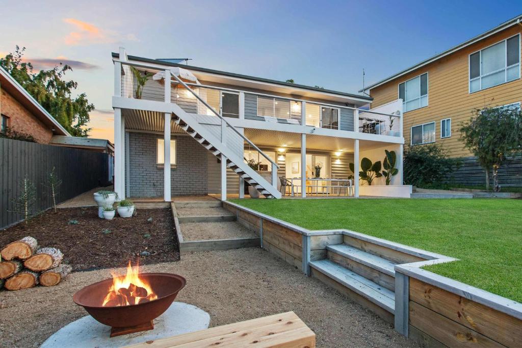 a backyard with a fire pit and a house at Luxe Oceanview - Bay Views Beach & Wineries in Dromana