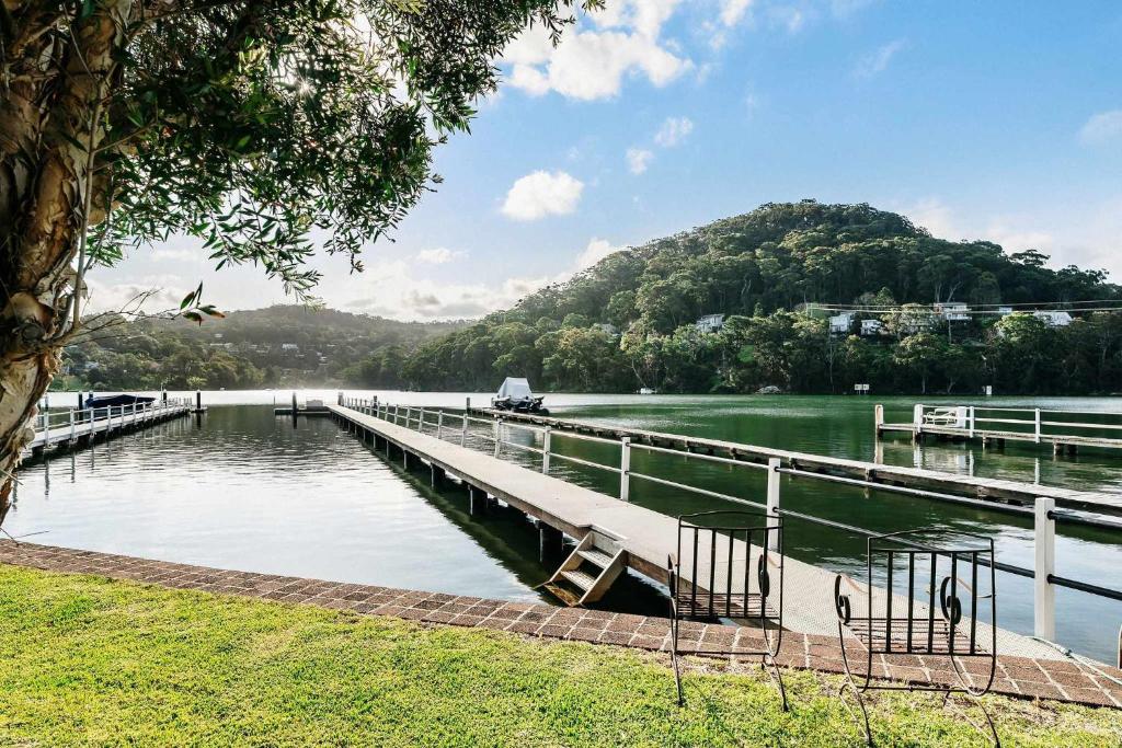 a dock on a lake with a mountain in the background at Casa Di Angelina By Coast Hosting in Blackwall