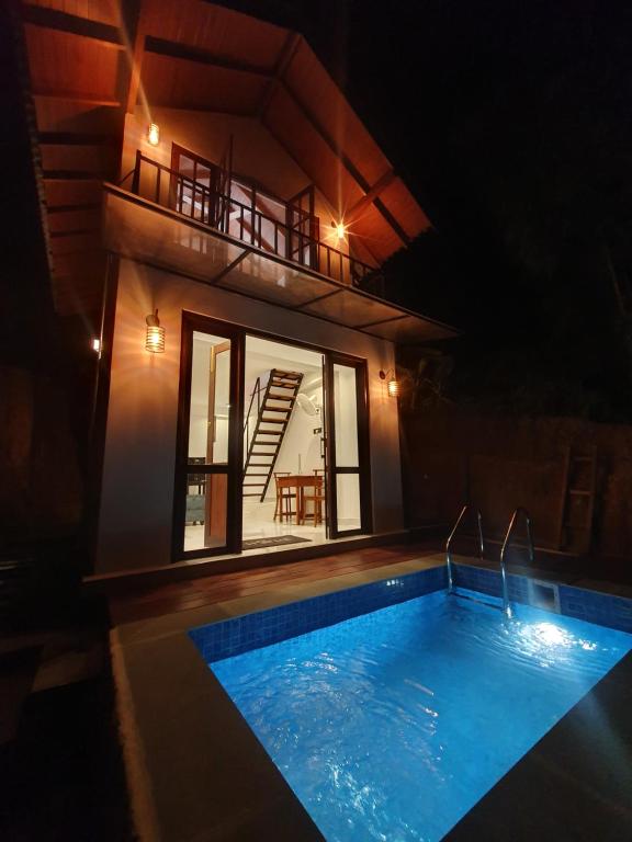 una piscina frente a una casa por la noche en Cinnamon Edge Mirissa, en Mirissa