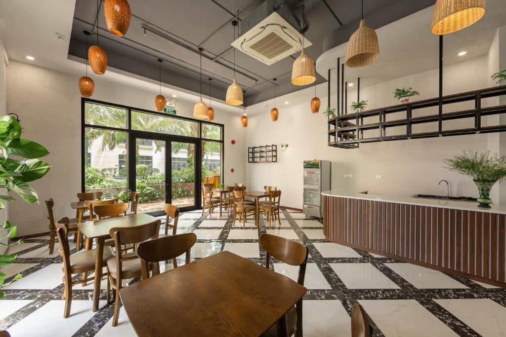 a restaurant with tables and chairs in a room at Hygg Hotel Phu Quoc in Phu Quoc