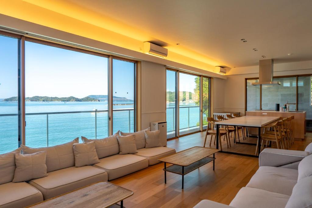 a living room with a large couch and a table at Nagisato Villa Clover in Takamatsu