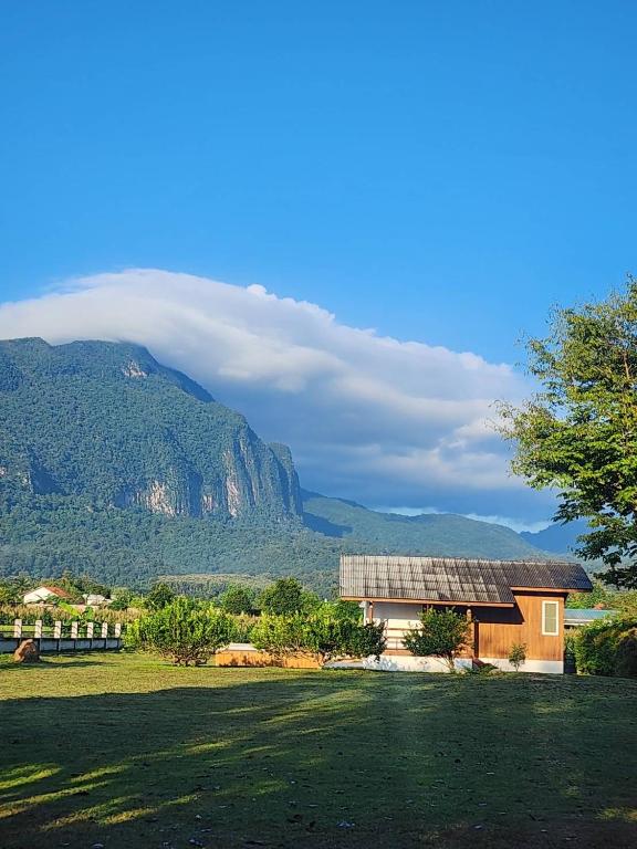 a house with a solar panel next to a mountain at Stay Day Off at Chiang Dao in Ban Mae Khon