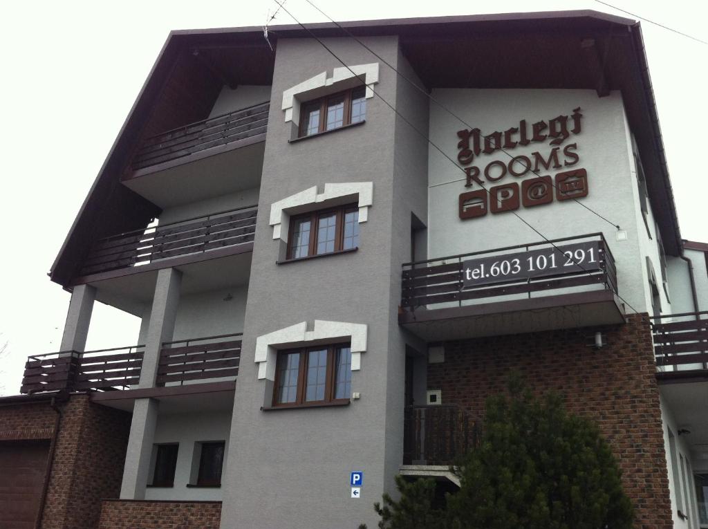 a building with a sign on the side of it at Route 7 Rooms in Myślenice