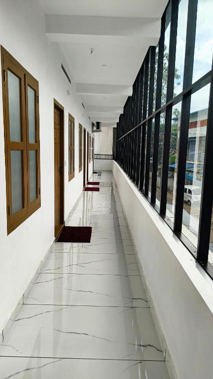 an empty corridor in a building with windows at Pynadath Square in Adūr