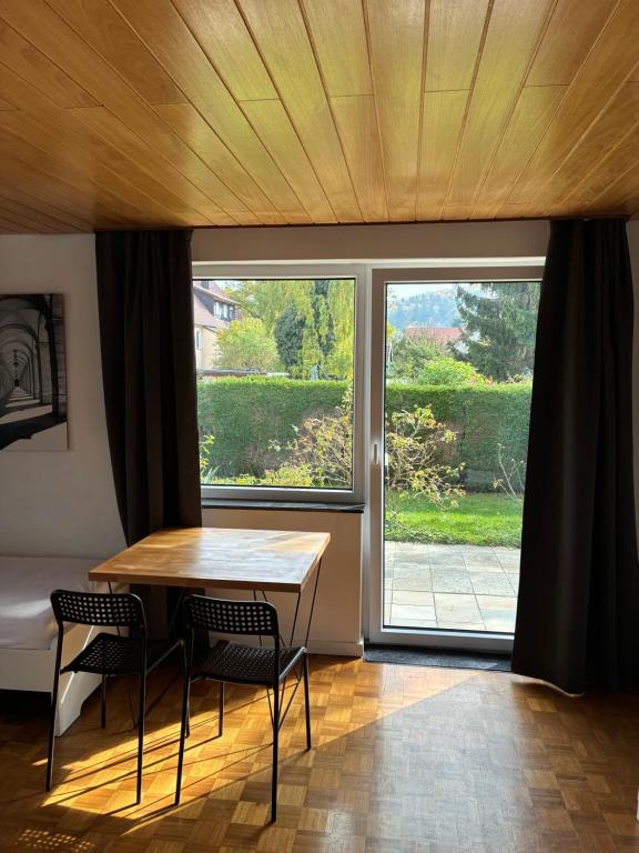 a room with a table and chairs and a large window at Schwabenperle Apartments in Lauchheim
