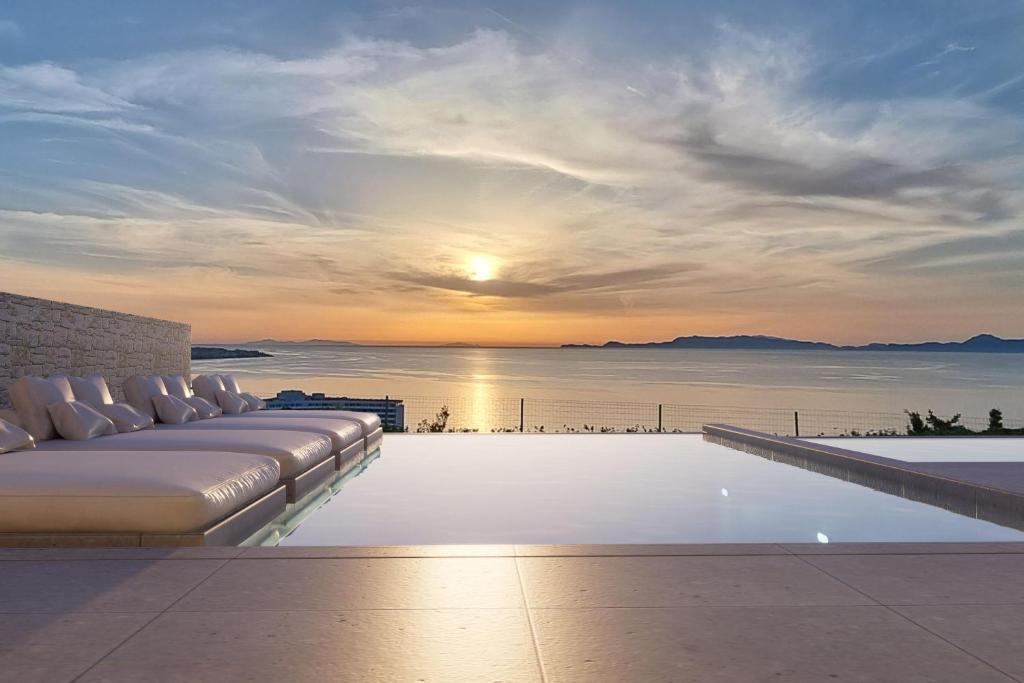 una piscina con cama y vistas al océano en Monte Smith Aether & Aura Villas, en Ixia