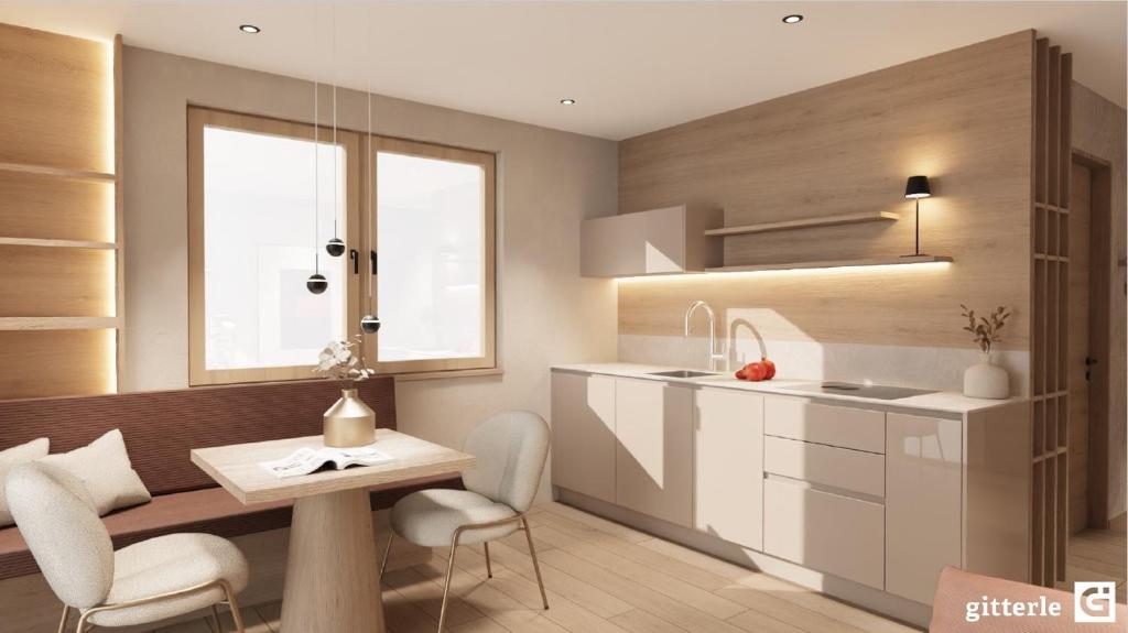 a kitchen with a table and chairs and a sink at Vista Apartments in Seefeld in Tirol