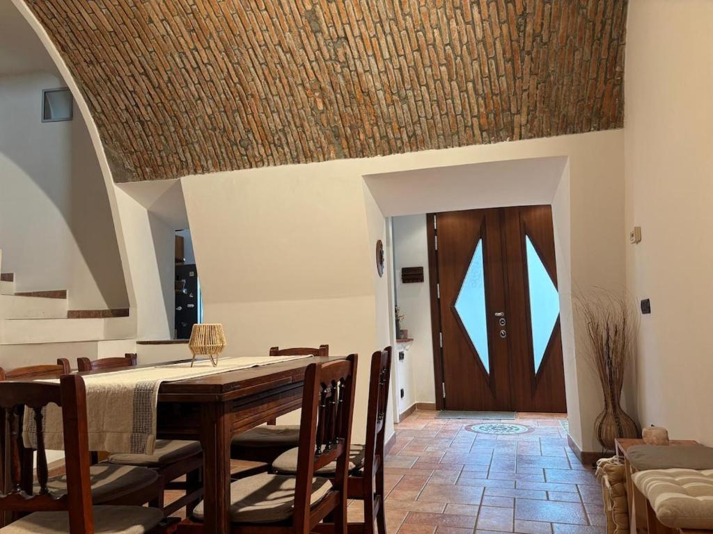 a dining room with a wooden table and chairs at Cozy Apartment Near Lake Como, Sleeps for 4 in Maslianico