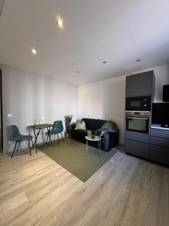 a living room with a couch and a table at Cozy apartment 15 minutes from Lyon in Saint-Fons