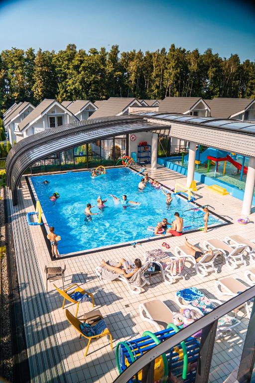 a group of people in a pool on a cruise ship at Collins Holiday in Ustronie Morskie