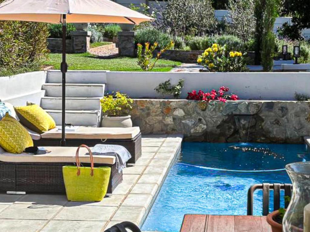 a patio with an umbrella and a swimming pool at Ginger Lake Wilderness in Wilderness