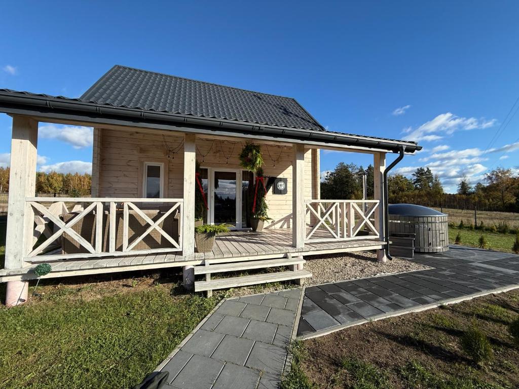 a small house with a porch and a fence at #Fuleda#Giżycko Fuledzianka domek na Mazurach #bania #jacuzziklimat in Giżycko