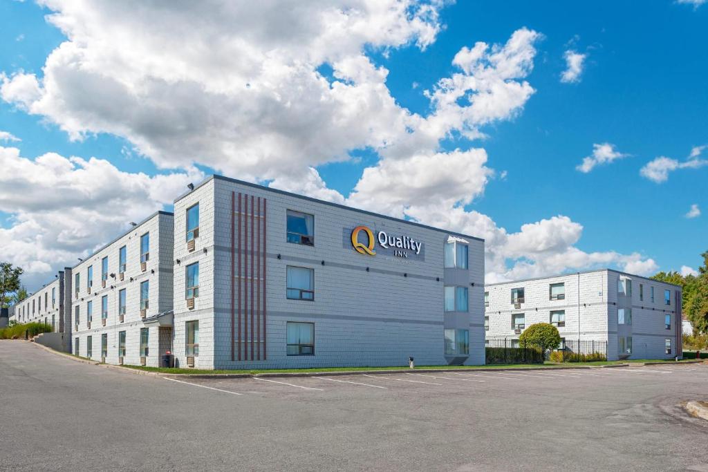 a large white building with a university sign on it at Quality Inn & Conference Centre in Midland