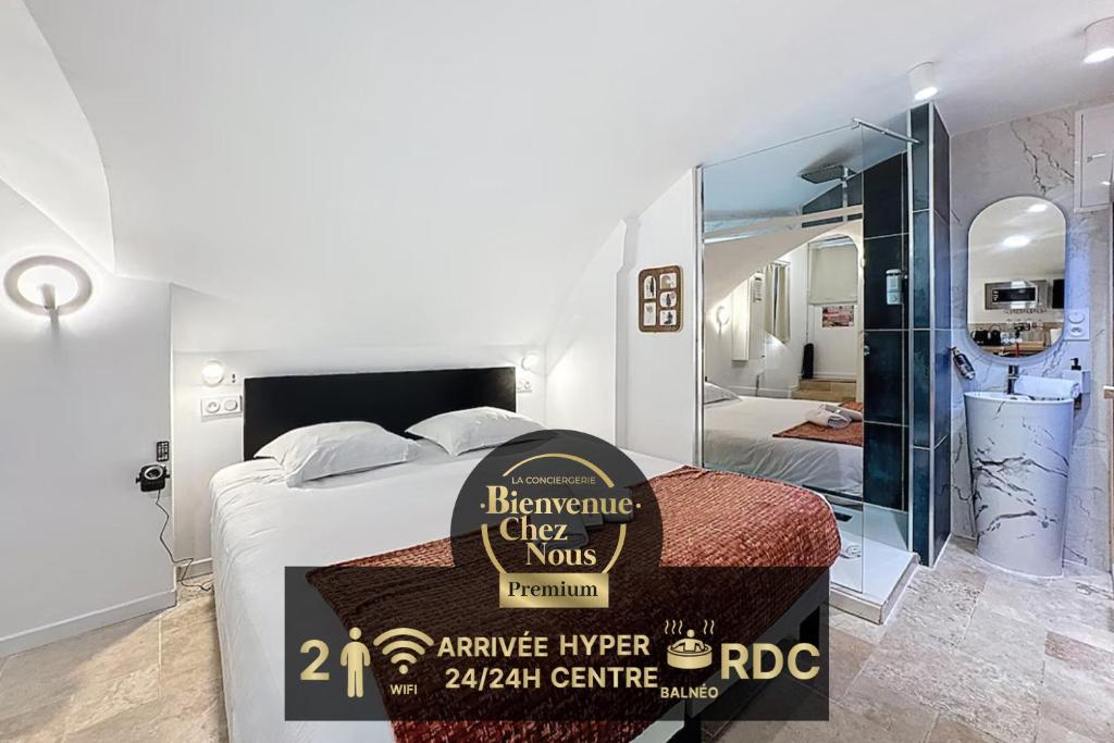 a bedroom with a bed with a sign on it at Love Room Beaumont Sauna et Balnéo in Beaumont