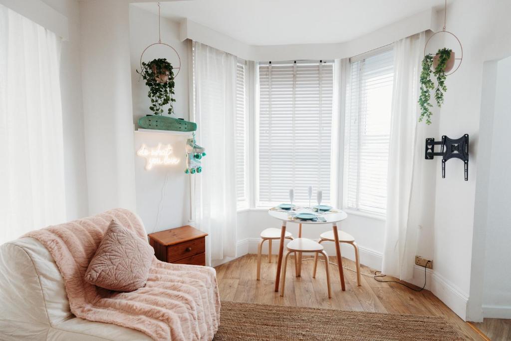 a living room with a chair and a table at Seaview Surf Studios in Newquay