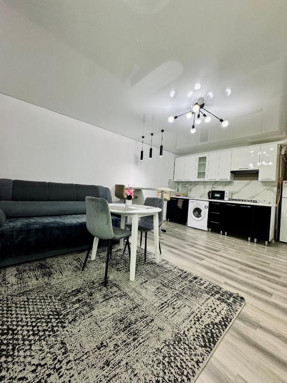 a living room with a table and a couch at APARTAMENT EDINET RENTAl in Edineţ