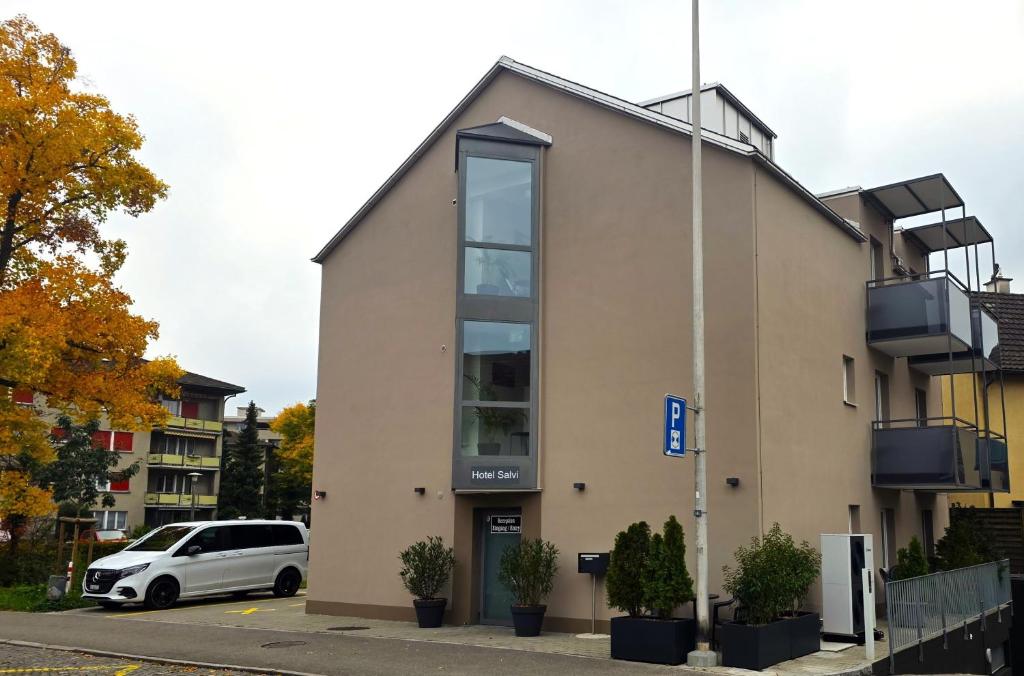 a white van parked in front of a building at Hotel Salvi in Kreuzlingen