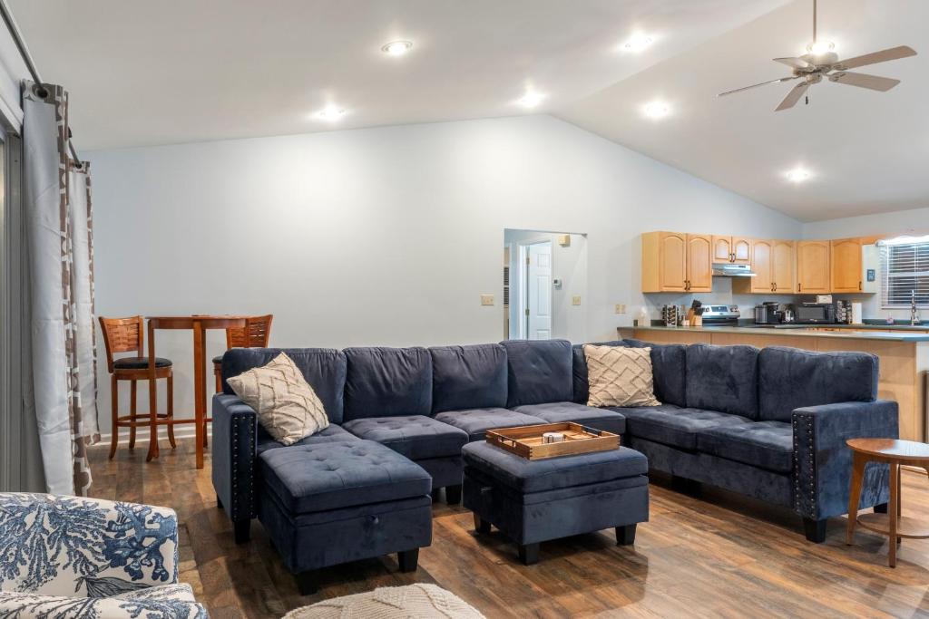 a living room with a blue couch and a table at New to listing Dorsey Dock Retreat w Dock in Hartwell