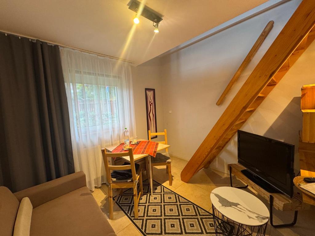 a living room with a couch and a table at LOFT-LUX Apartment in Jelenia Góra