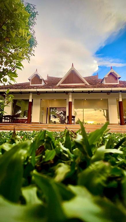 a house with a garden in front of it at Vembanad Ripples in Alleppey