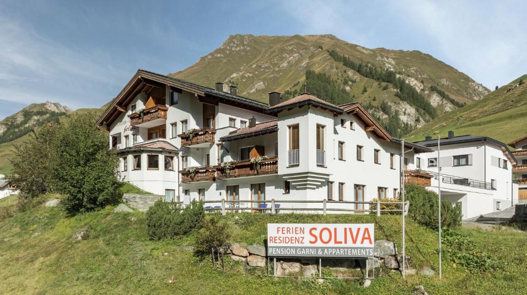 a building on a hill with a sign in front of it at Soliva Hotel & Apartments by MEIN SAMNAUN - MOUNTAIN HOMES in Samnaun