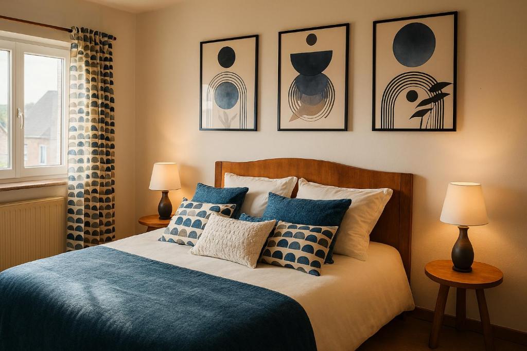 a bedroom with a bed with blue and white pillows at Ancienne Fermette le Charlemont Givet Foisches in Foisches