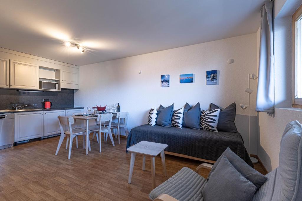 a living room with a couch and a table at Pracondu 2 304 - OUTDOOR & FUN apartment 6 pers in Nendaz