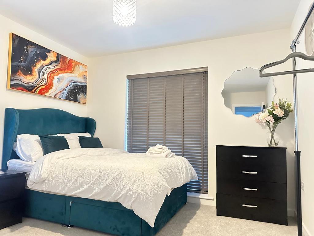 a bedroom with a blue bed and a window at 4 Bed House - Sleeps 7 - Pets - Parking - Wifi in Bushbury