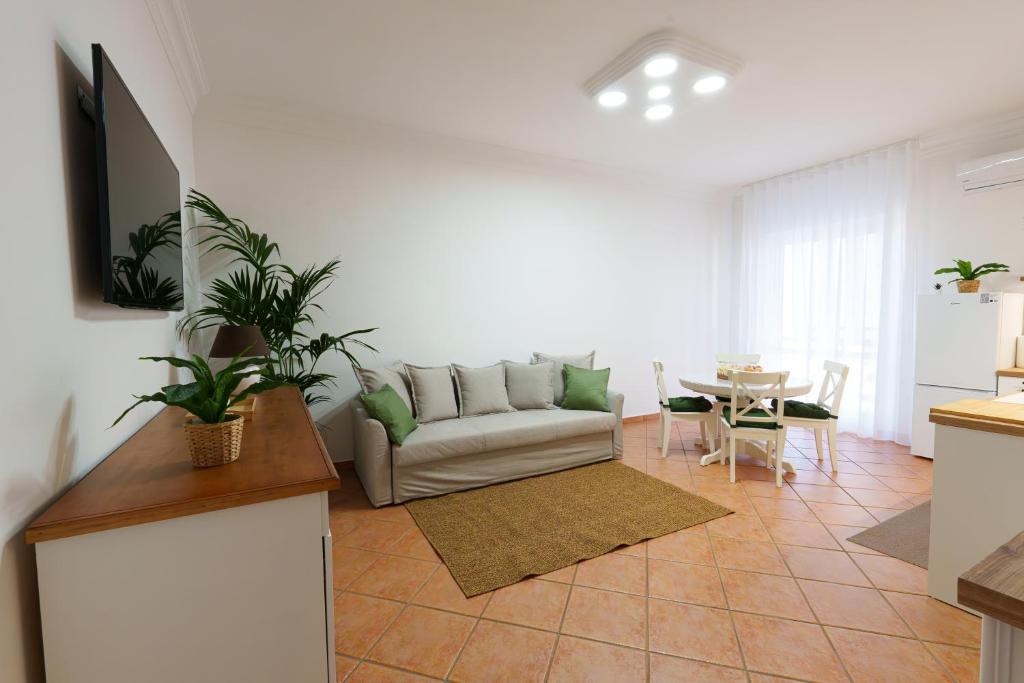 a living room with a couch and a table at House Marisa 5 minutes from the airport in Casoria