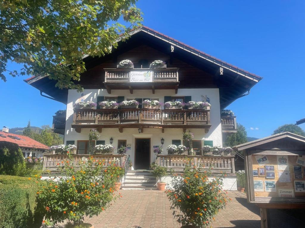 a building with a balcony with flowers on it at Gästehaus Baier am Bad in Bad Wiessee