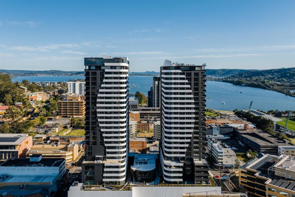 an aerial view of two tall buildings in a city at voco Gosford by IHG in Gosford