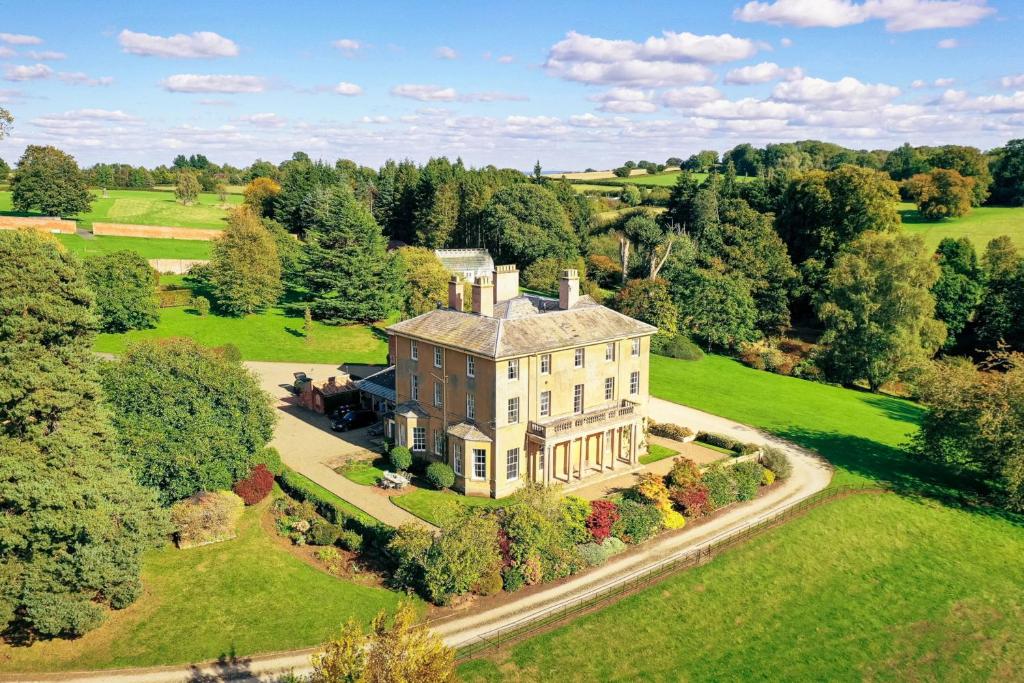 an aerial view of a large house on a green field at Hopton Court Apartment in Hopton Wafers