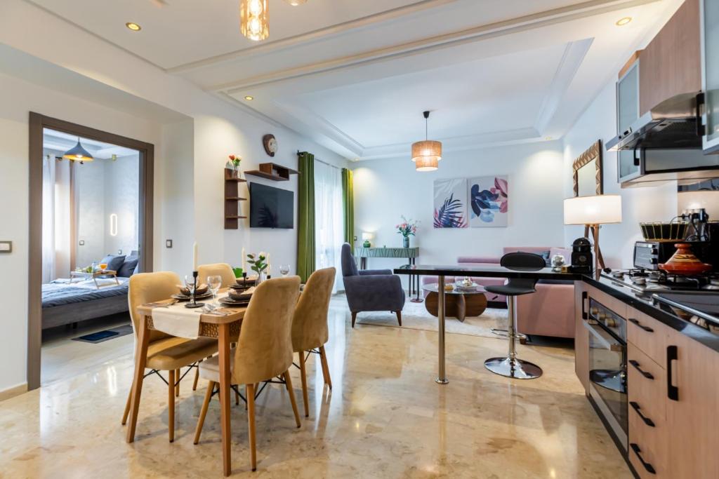 a kitchen and dining room with a table and chairs at Luxury & elegant Apartment, Parc Serenity in Mohammedia