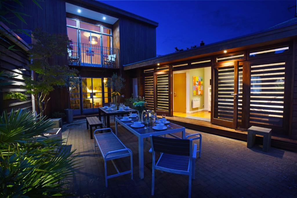 a patio with tables and chairs and a building at Cedar House Canterbury in Canterbury