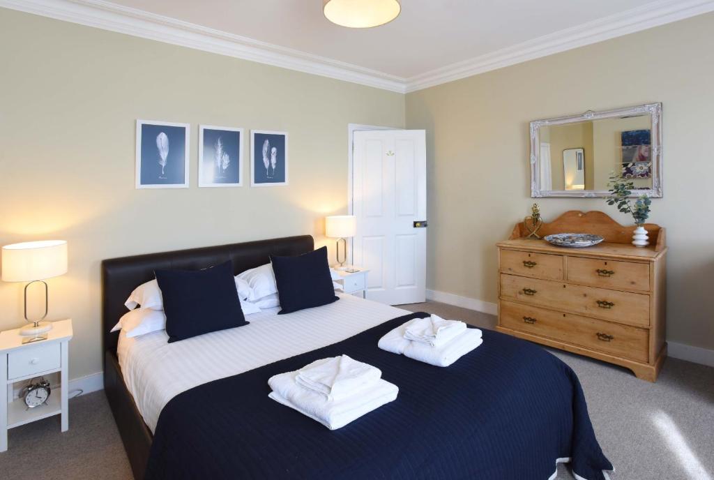 a bedroom with a bed with two towels on it at Arthouse in Canterbury