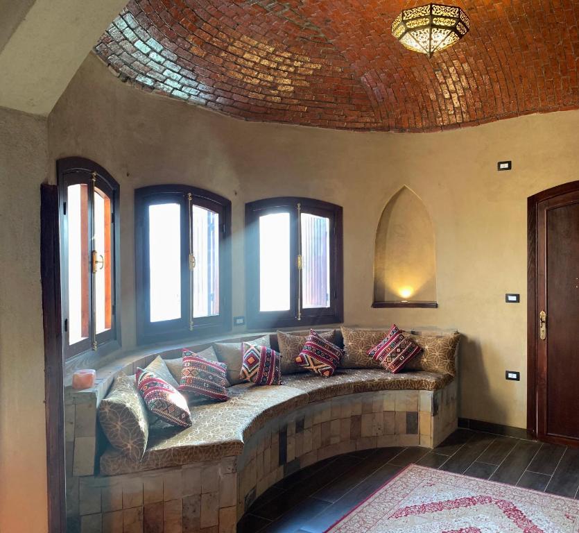 a large couch in a room with windows at Villa Nur in Luxor