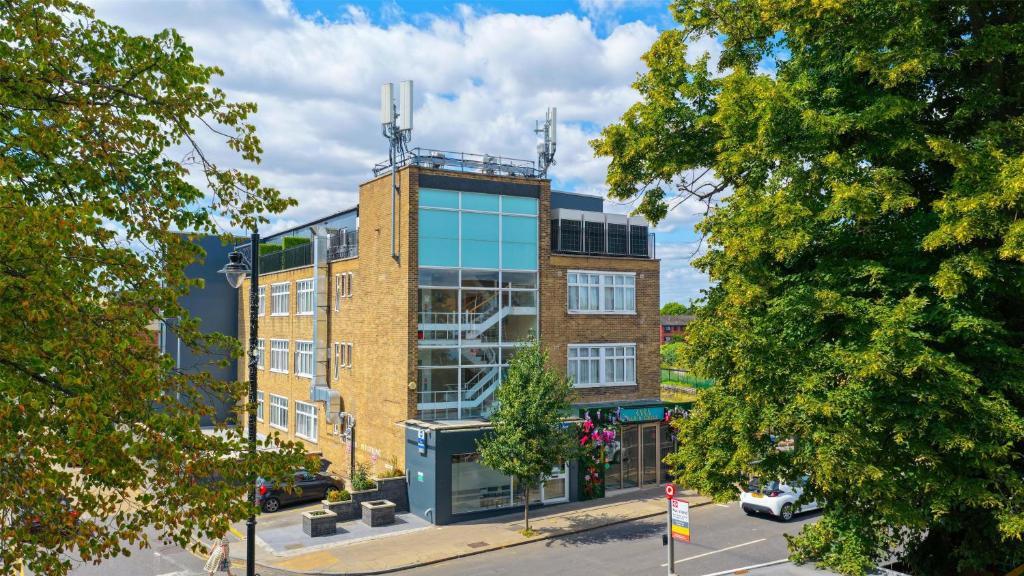 a tall brick building with a glass at Best Western Northfields Ealing Hotel -Northfield station Elizabeth line in London