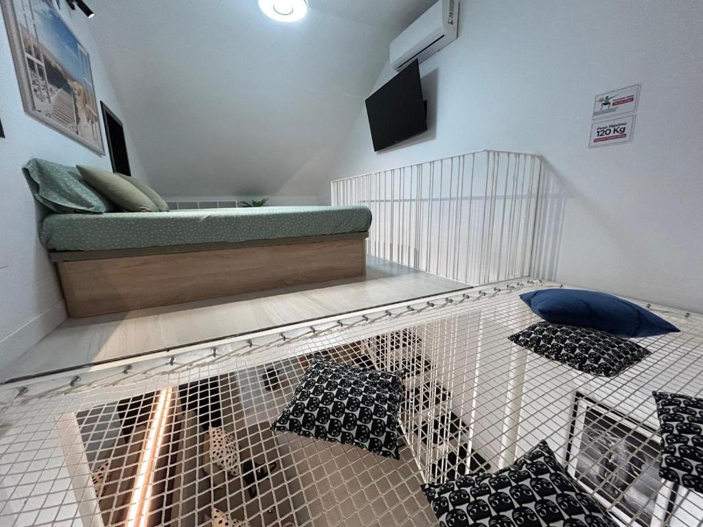 a bird cage with pillows in a room at Carihuela Home in Torremolinos