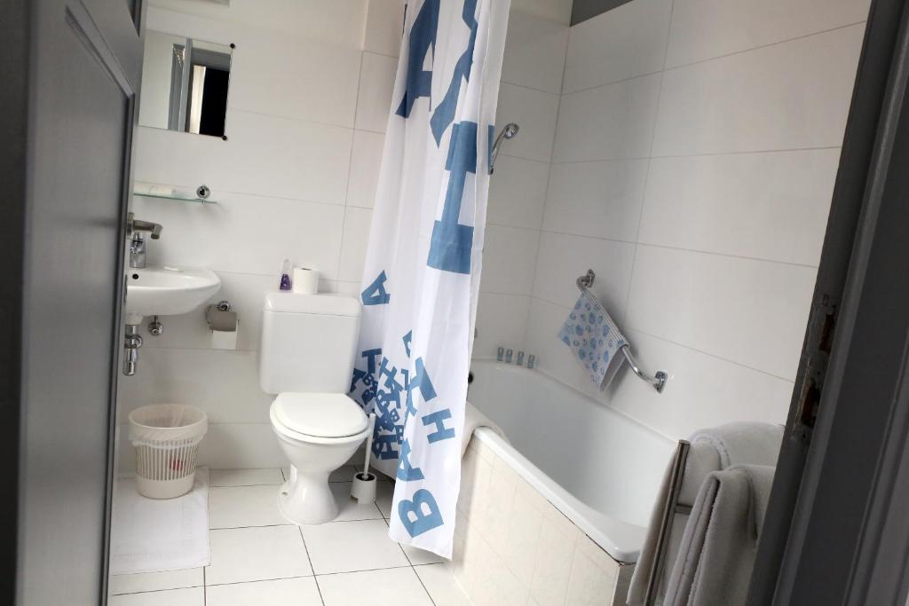 a bathroom with a toilet and a sink at Eurotel in Liège