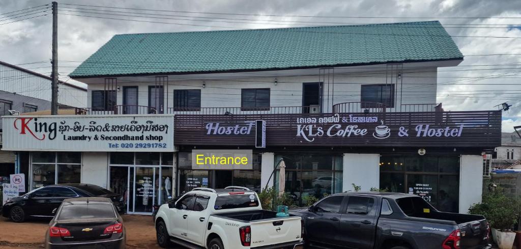 a white truck parked in front of a building at KL's Coffee & Hostel in Pakse