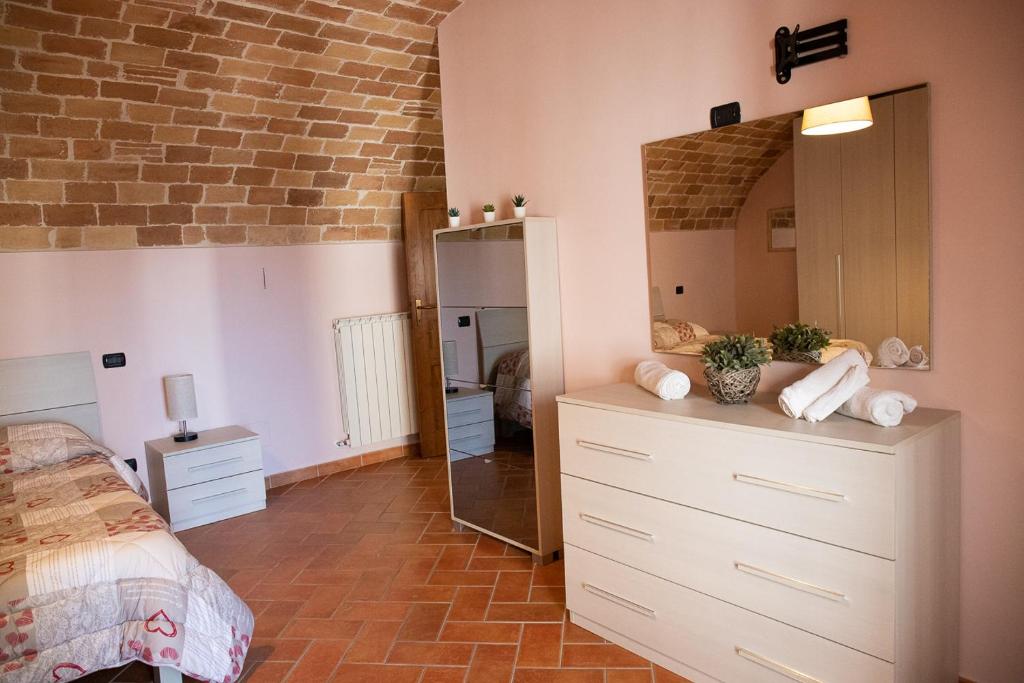 a bedroom with a dresser and a mirror at La Rusacca Pacentro in Pacentro